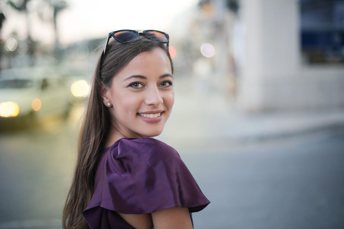 An elegant woman with a warm, natural smile